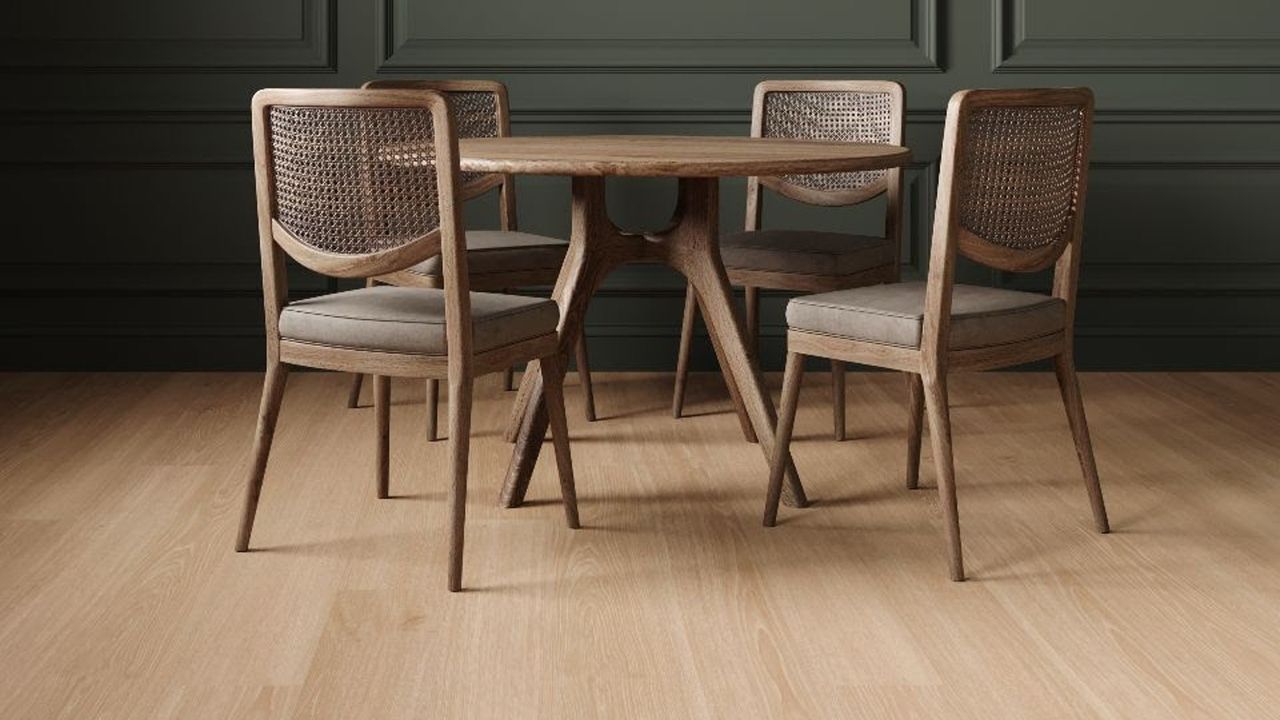 laminate wood flooring with a wooden dining table and chairs, and a green panelled wall beyond