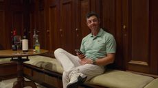 Rory McIlroy sits down in the locker room after winning the FedEx Cup