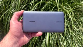 The Ugreen 25,000mAh power bank in the hand.