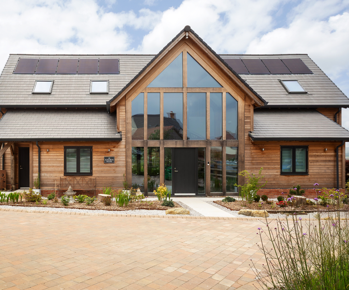 Exterior of oak frame house with patio in front