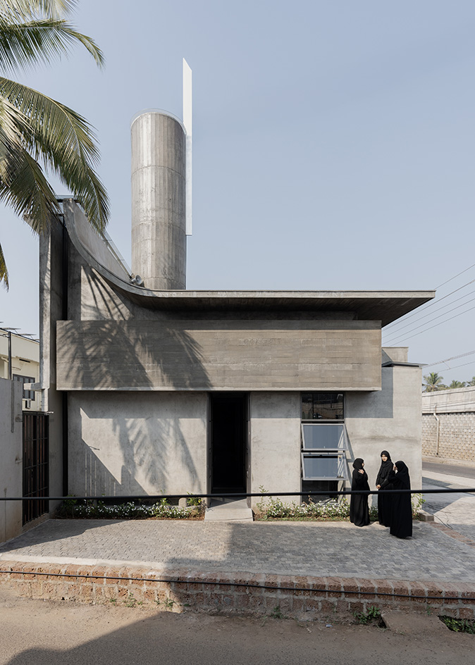 Brutalist mosque in Kerala, concrete structure against blue skies
