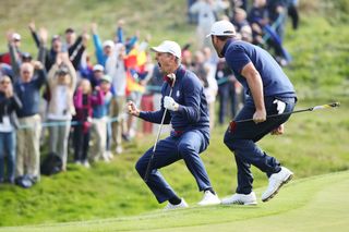 Justin Rose celebrates with Jon Rahm after chipping in at the 2018 Ryder Cup