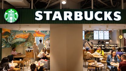 Customers sit at a Starbucks coffee store