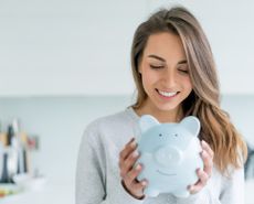 Woman holding a piggy bank