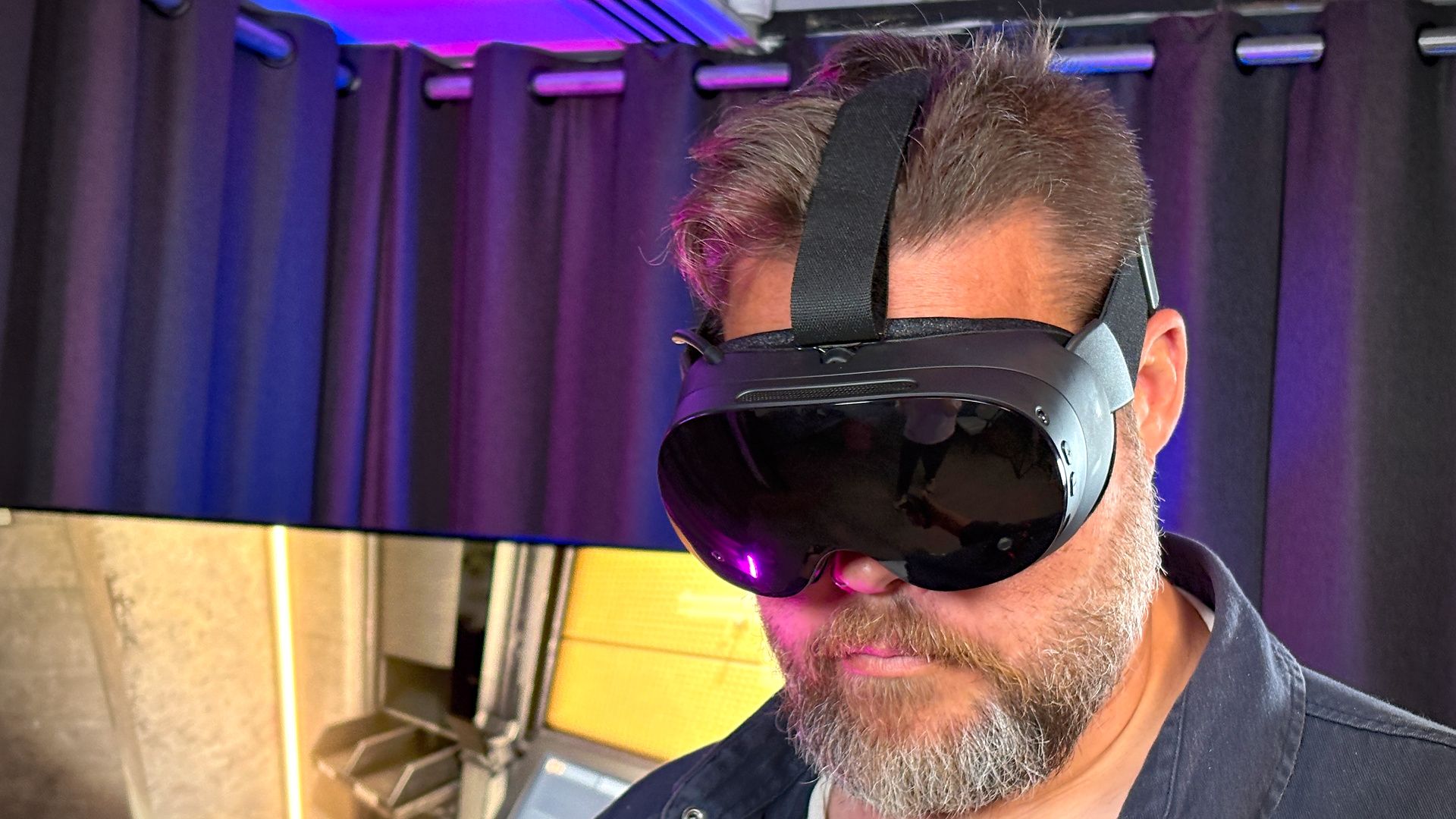 Dave James, PC Gamer EIC for Hardware, wearing the Steam Frame while playing a game in VR.