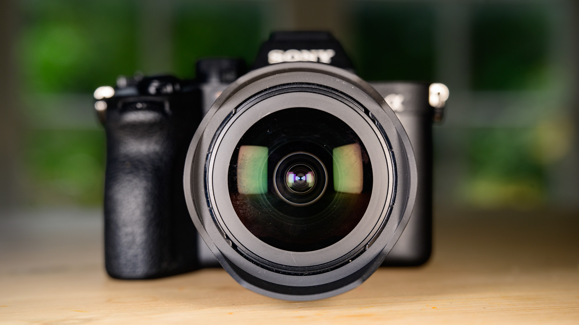 Sony FE 8-14mm F3.5 G fisheye lens attached to a Sony A7R V camera, close up of the bulbous front element