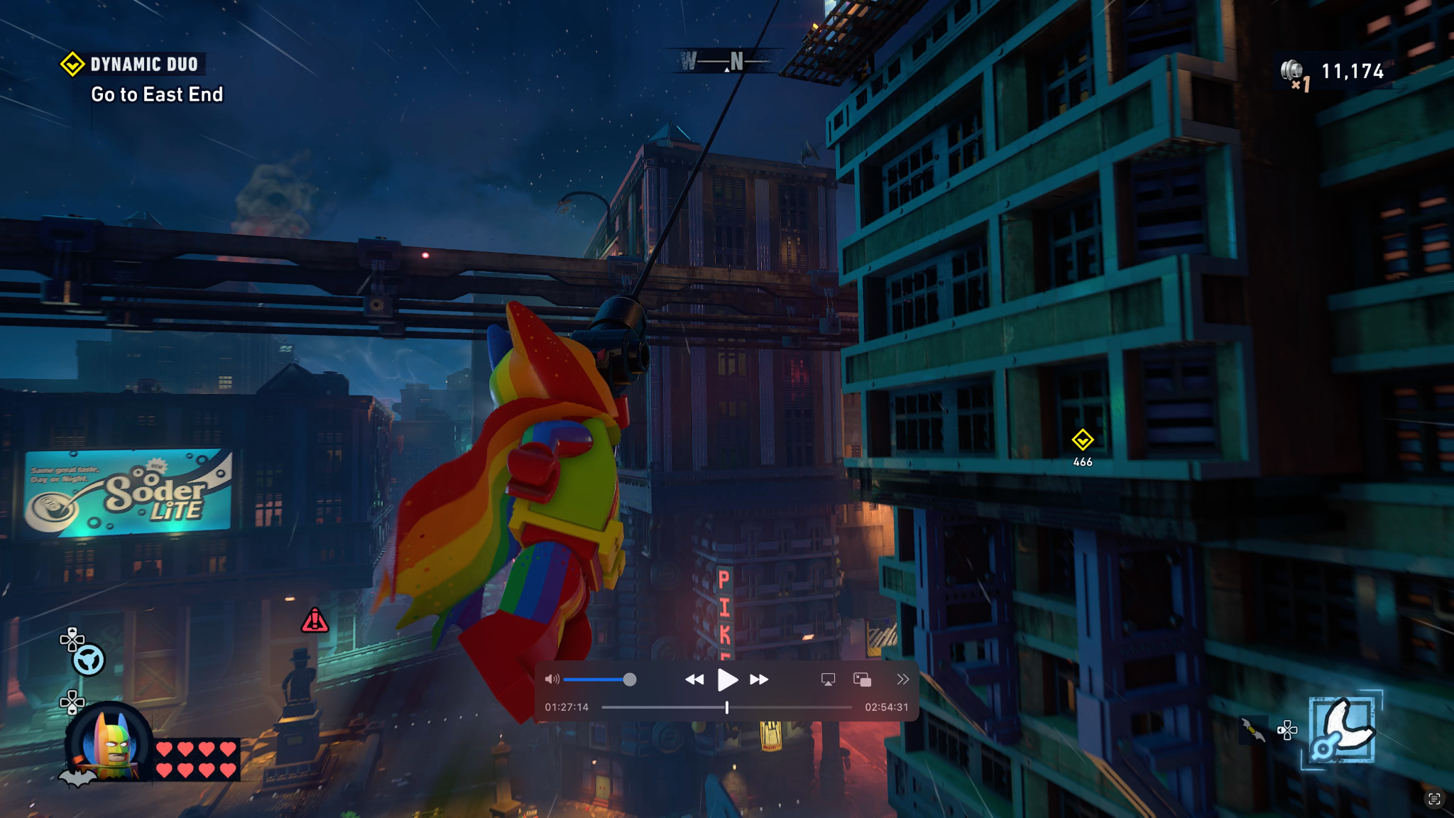 Batman grapples up a building in Lego Batman: Legacy of the Dark Knight