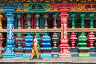 Asian woman at the entrance to Batu Caves, Kuala Lumpur, Malaysia.