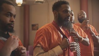 Incarcerated fathers are shown tying neckties in preparation for a Daddy Daughter Dance in the trailer for the Netflix documentary Daughters.