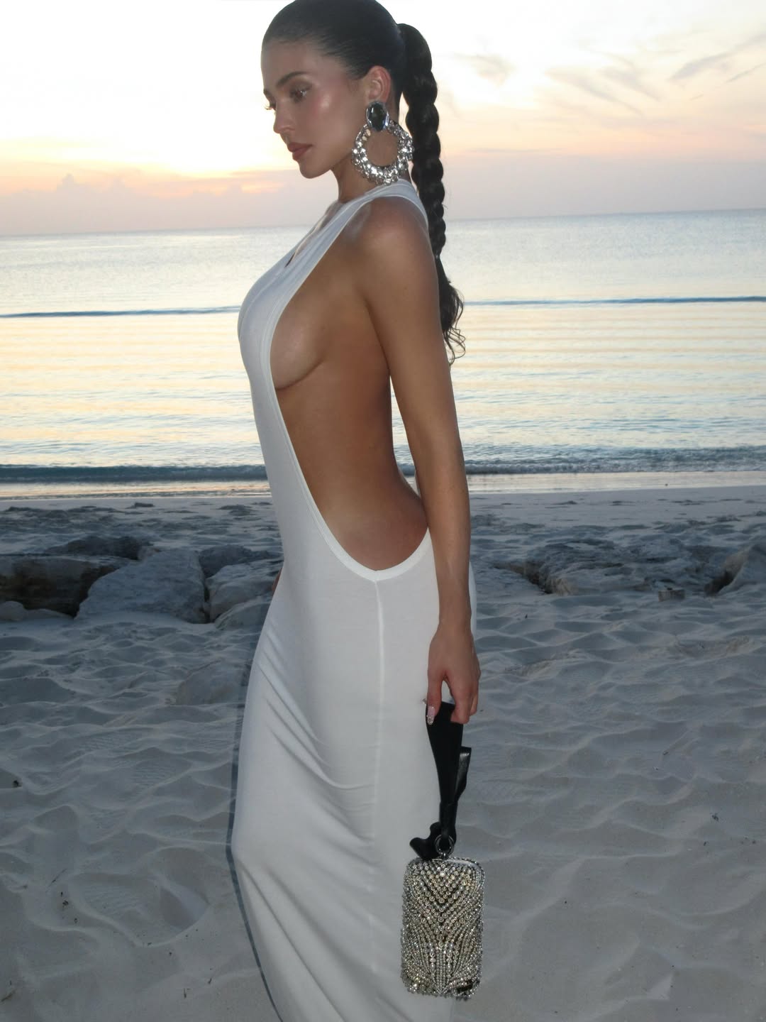 Kylie Jenner wore a little white Jacquemus dress with deep side cut-outs on vacation