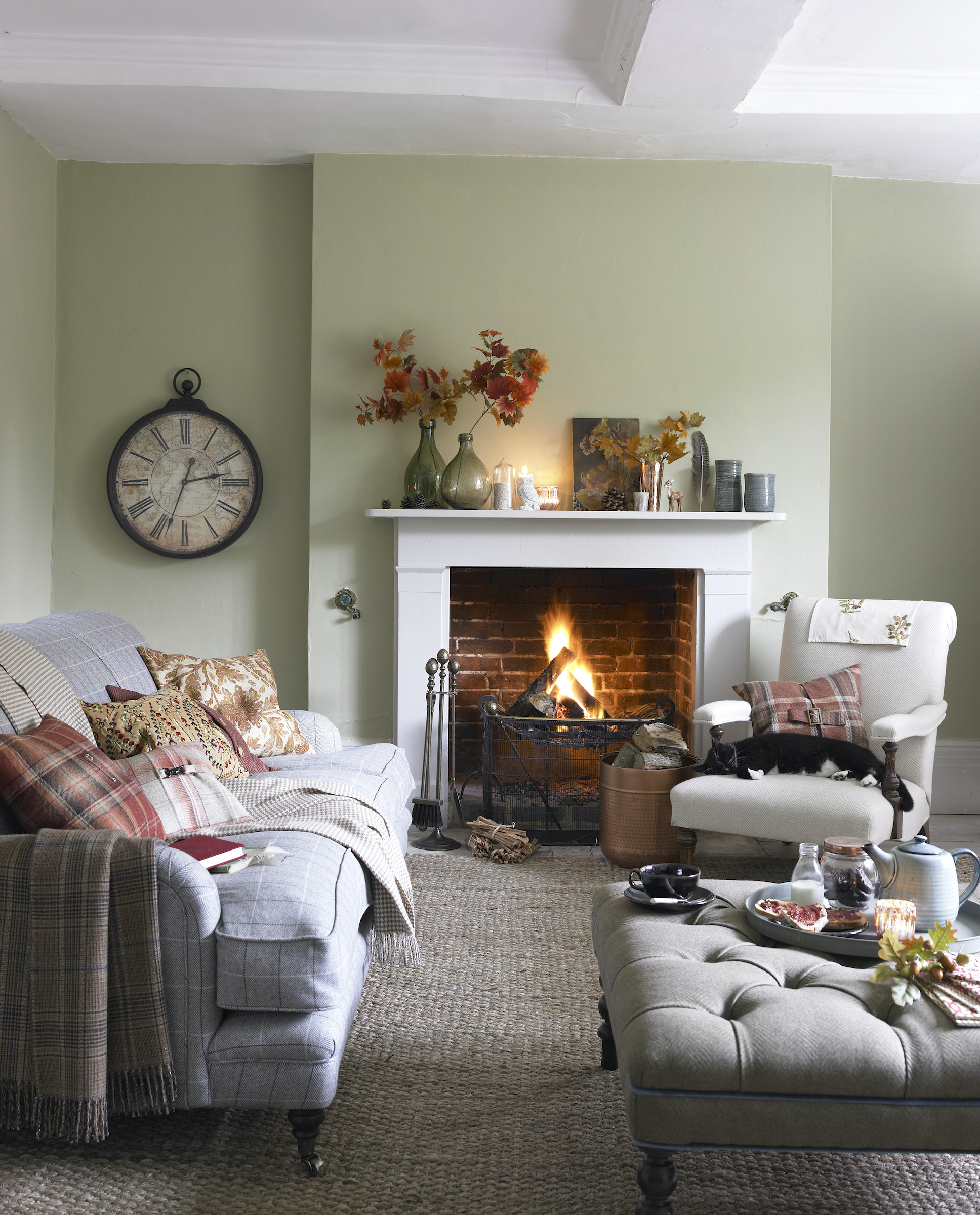 living room with green walls and clock