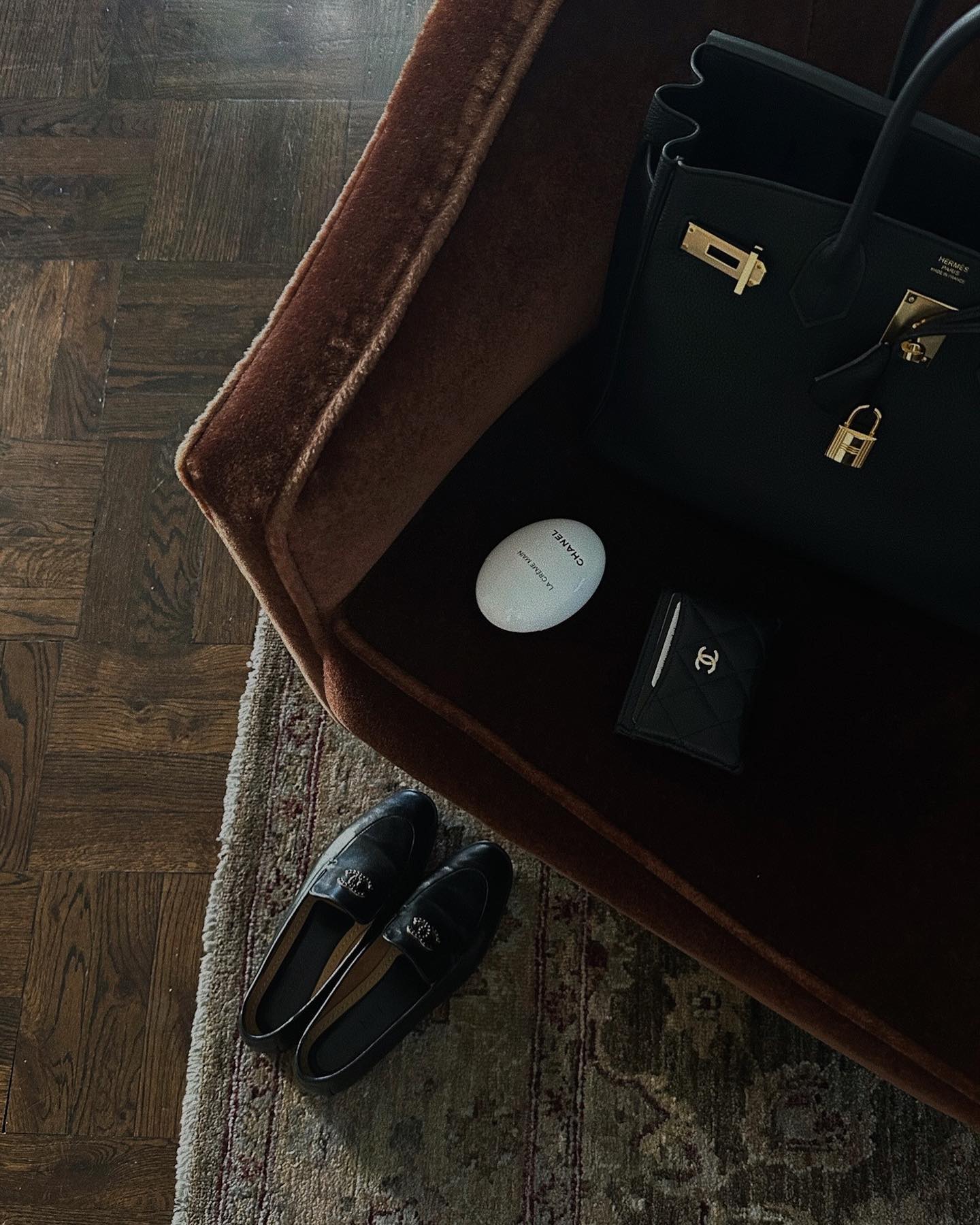 An image of Jaz Tookes with an Herm&amp;egrave; Birkin and Chanel loafers.