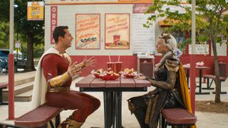 Shazam and Hespera sit at a fast food table to discuss matters in Shazam! Fury of the Gods