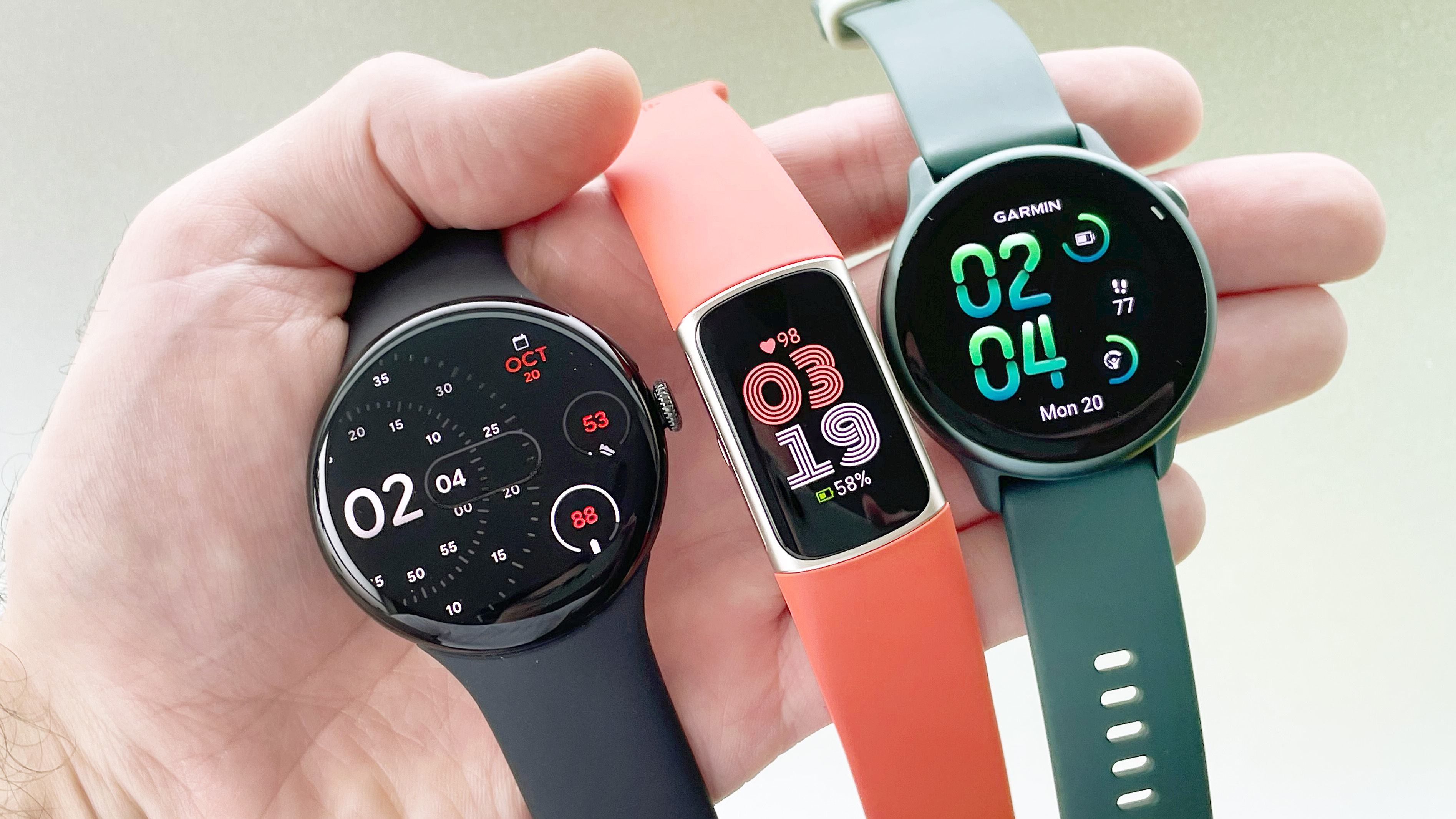 Close-up of the Pixel Watch 4, Fitbit Charge 6 and Gamin Vivoactive 6