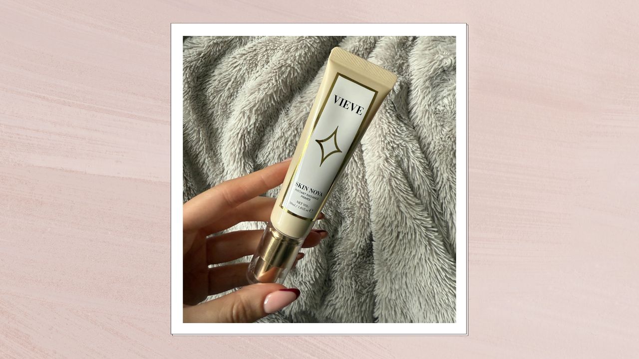 Image of hand holding Vieve&#039;s Skin Nova Primer on a pink background