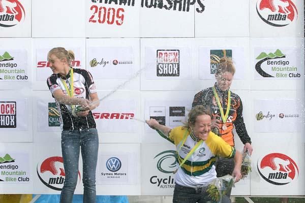 The elite women's podium gets to enjoy some champagne.