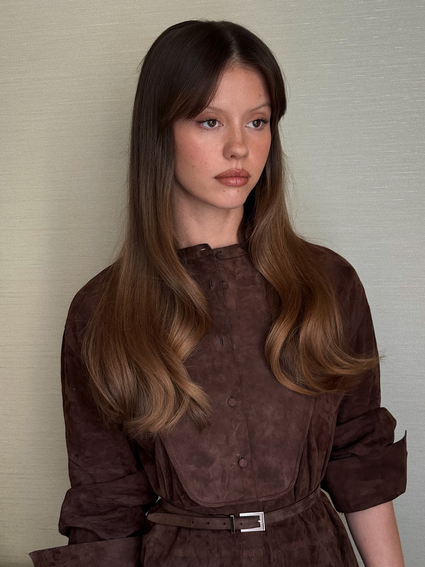 Mia Goth with colour-melted brunette hair with golden brown lengths