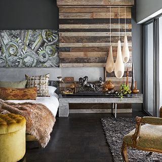 master bedroom with wood wall and three pod lights