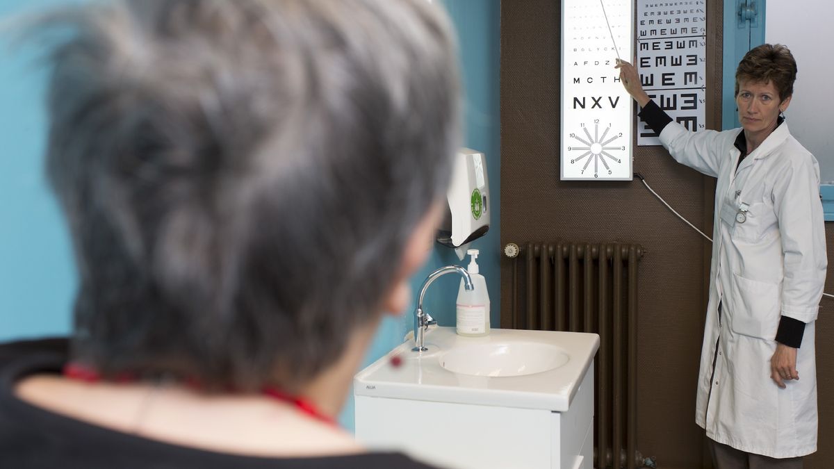 An older woman completes a vision exam in the doctor&#039;s office