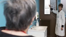 A woman completes a vision exam in the doctor's office