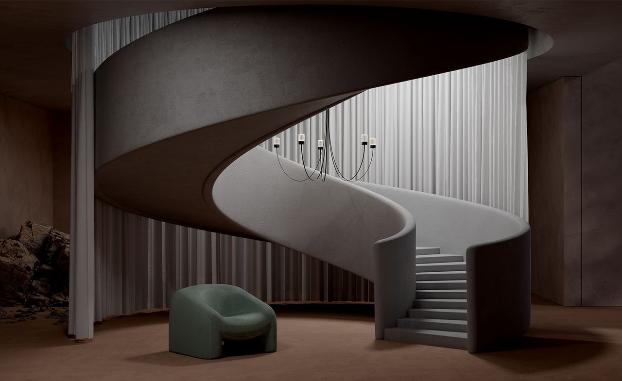 A render showing Paul Cocksedge&#039;s Gravity Chandelier for Moooi, a design featuring black curved arms hanging from the ceiling over a spiral staircase. In the background is a large scale gray curtain and a green armchair is on the floor below