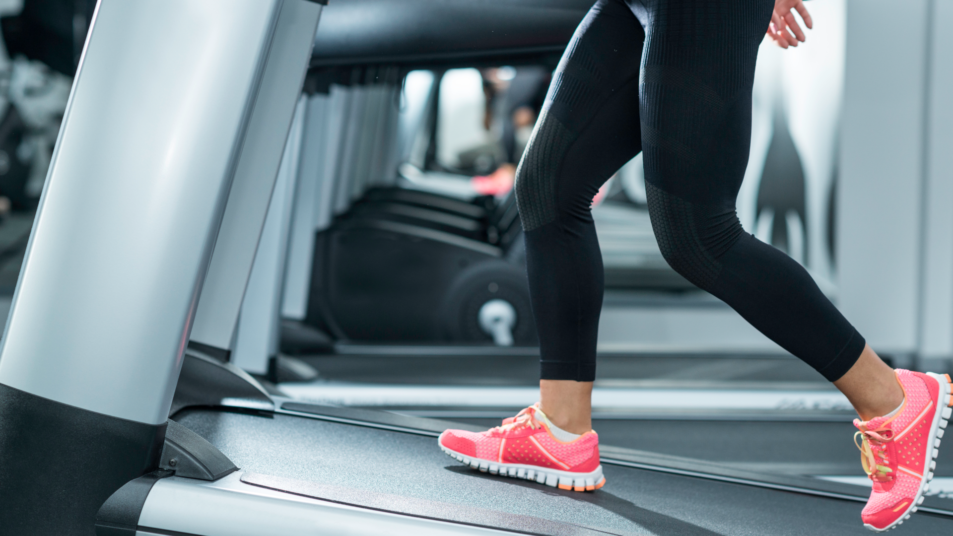 A woman walking on a treadmill on an incline