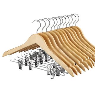 12 wooden clothes hangers with trouser clips on the metal cross bars stacked together