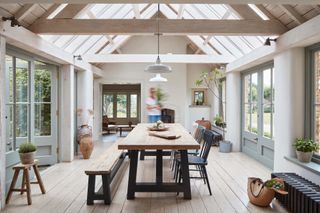 dining room in timber conservatory extension with wooden flooring