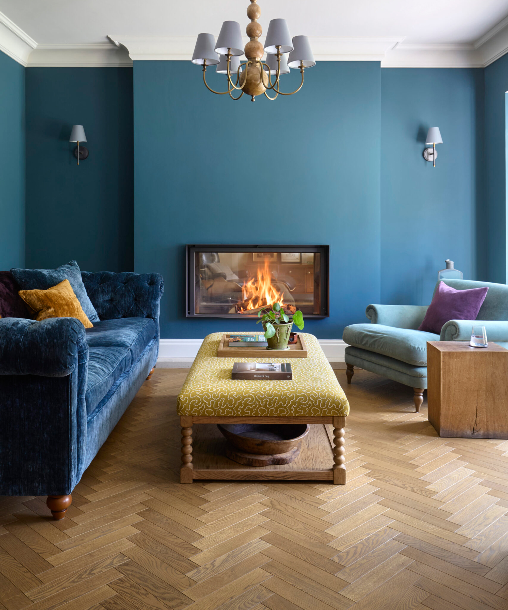 blue living room with herringbone engineered flooring and modern fireplace