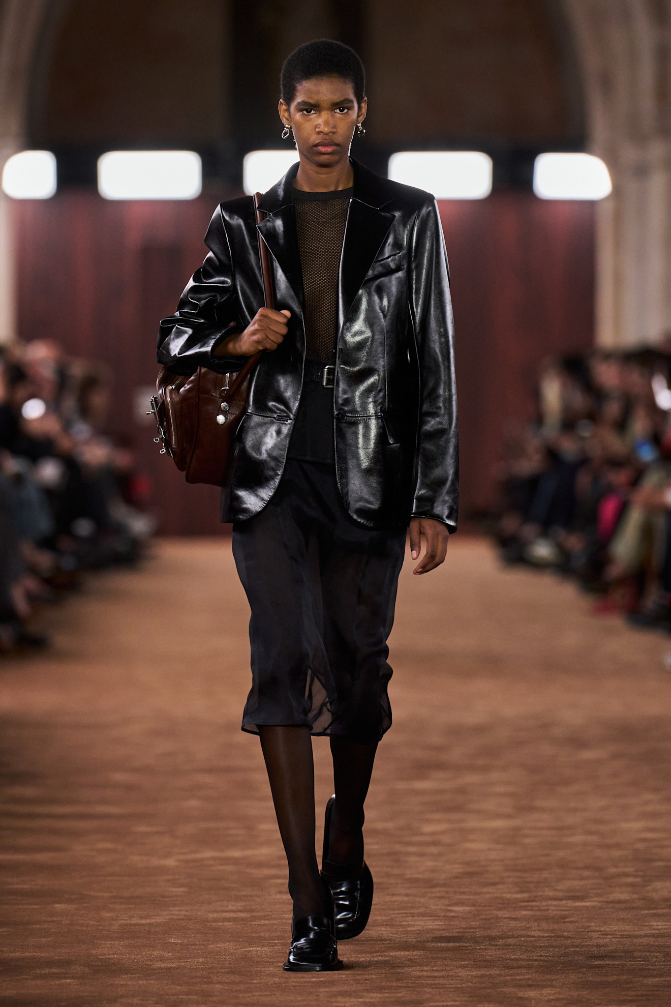 Acne Studios model wearing a leather blazer in the Spring 2026 show