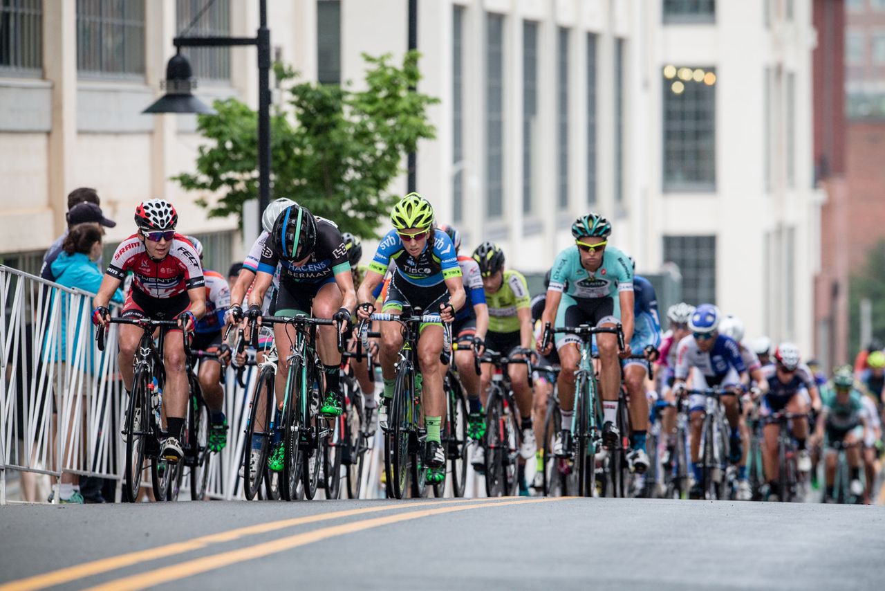 The womens field bunches up over the steep climb.