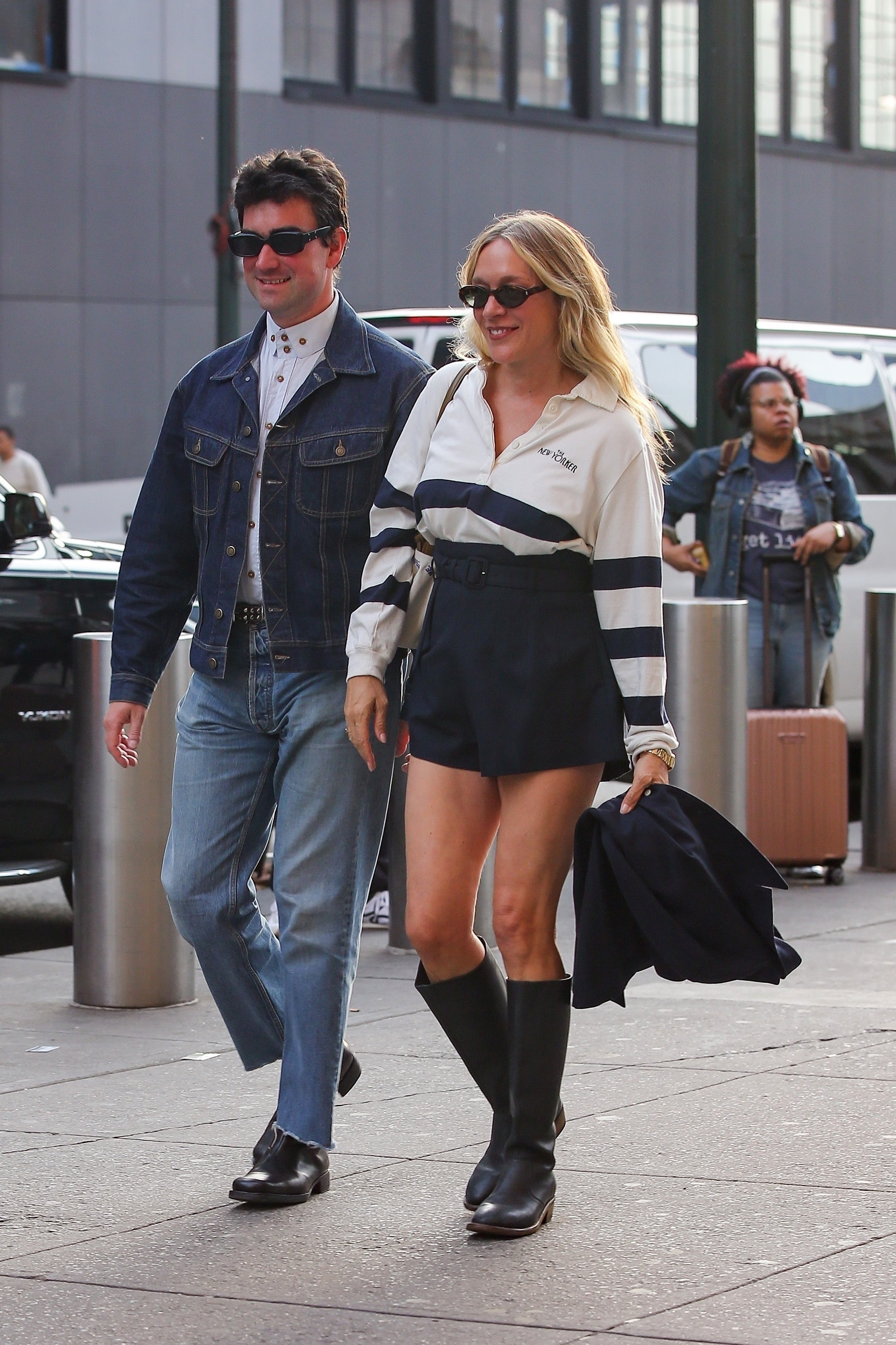 Chloë Sevigny is seen with husband Siniša Mačković in New York wearing shorts, black boots, and a J.Crew The New Yorker shirt, matching with a brown bag and a Knicks hat.