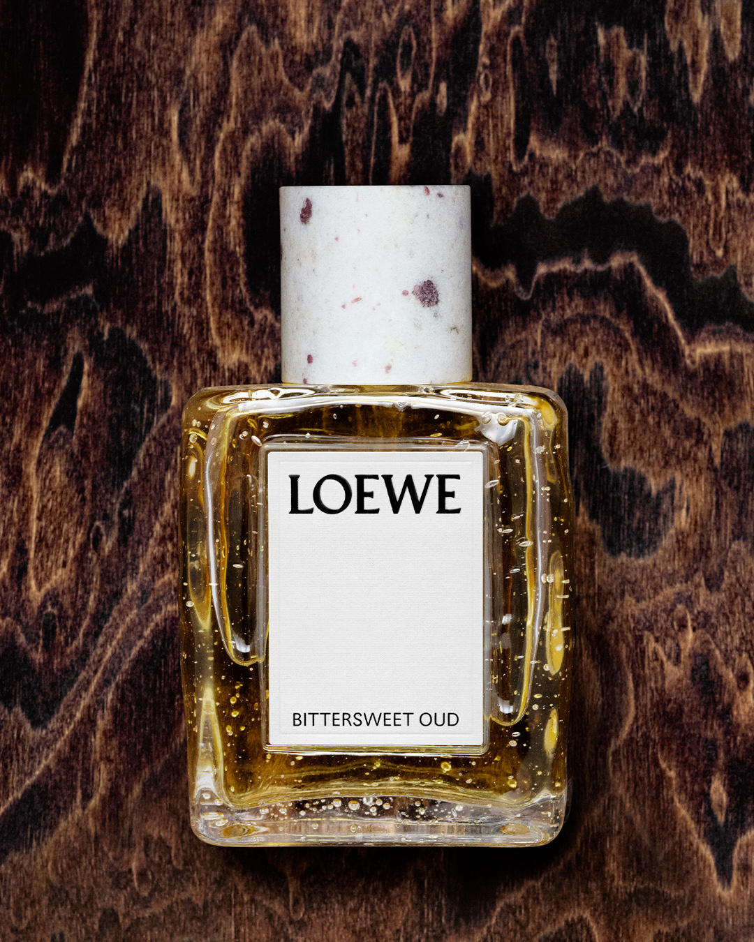 loewe fragrance bottle against a floral background