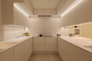 a minimalist cream kitchen using sustainable led lighting