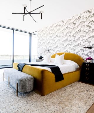 bedroom with mustard bed and wallpaper
