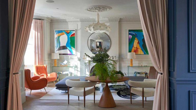 living room lighting ideas large living room with orange chairs, white walls and brightly colored artwork