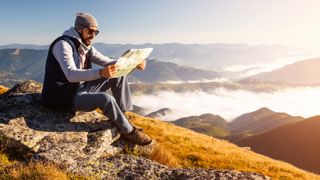 Man reading a map in the mountains