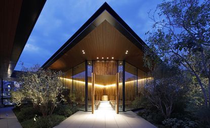 clean-lined wooden rooftop chapel surrounded by trees and gardens