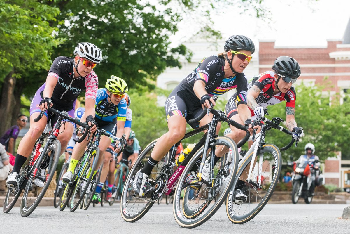 A Visit Dallas Cycling DNA Pro Cycling rider at the front