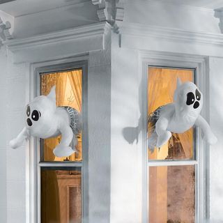 halloween ghosts in a window