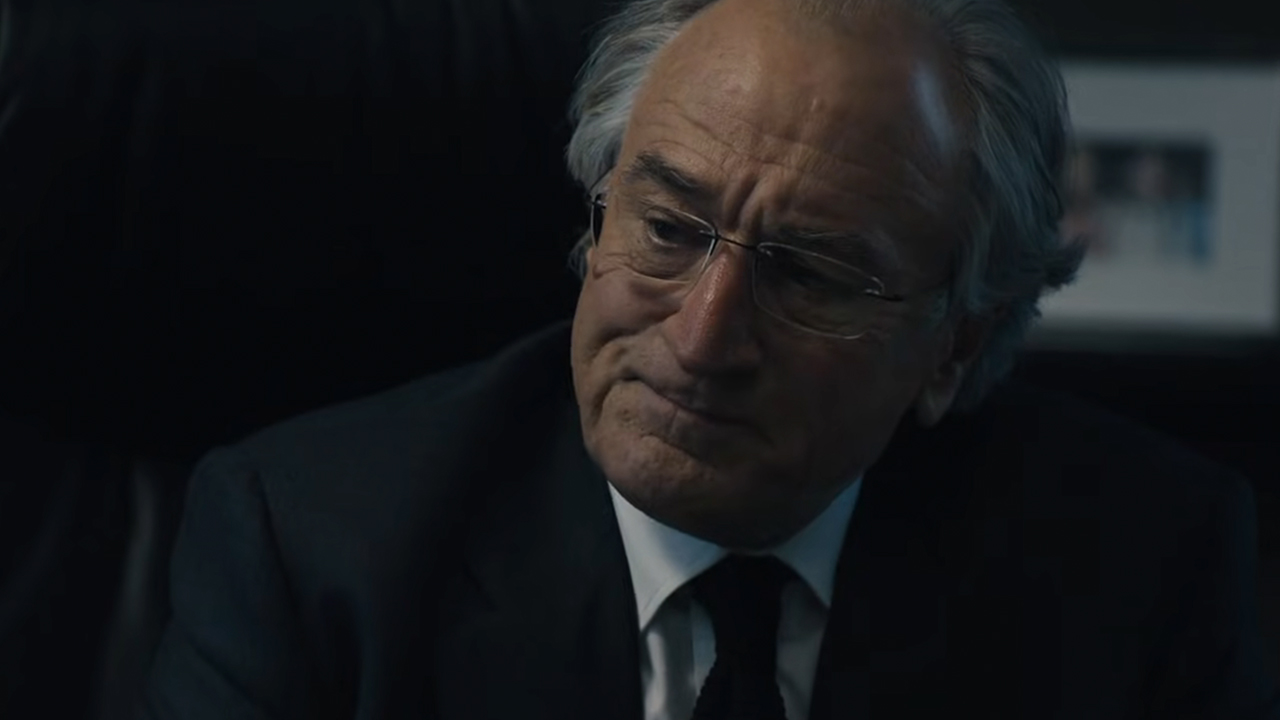 Robert De Niro looking pained in a suit, as Bernie Madoff in The Wizard of Lies