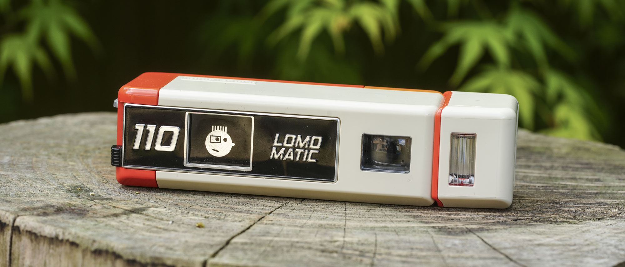 A close up image showing the controls of the Lomography Lomomatic 110 film camera