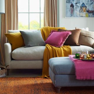 Pebble grey sofa with colorful accessories