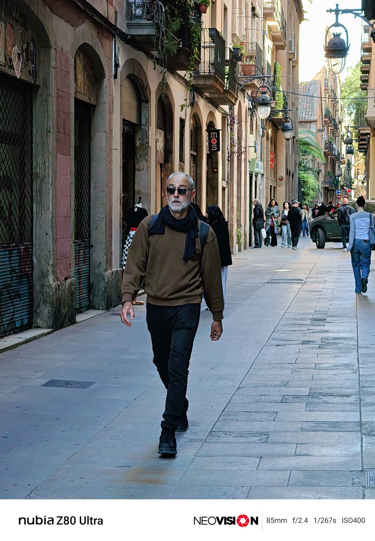 A man walking down a street in Barcelona