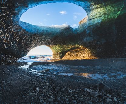 Sunrise over Ice caves at the Breidamerkurjokull glacier, part of the Vatnajokull glacier, in the very early hours of the winte day