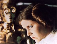 1977 TCF/Lucas film starring Carrie Fisher as Princess Leia Organa here with See Threepio played by Anthony Daniels