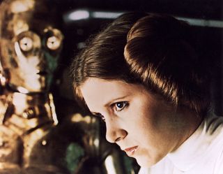 1977 TCF/Lucas film starring Carrie Fisher as Princess Leia Organa here with See Threepio played by Anthony Daniels