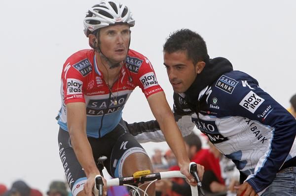 Frank Schleck (Saxo Bank) is helped across the line.