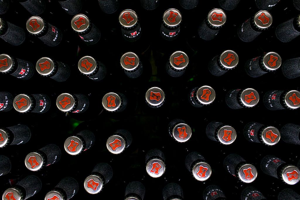 The Beck&#039;s key logo sits on bottle tops on the production line at the Beck&#039;s brewery, operated by Anheuser-Busch InBev NV, in Bremen, Germany, on Wednesday, Nov. 4, 2015. U.K. regulators gave AB InBev yet another week to make a formal takeover offer for SABMiller Plc as the two brewers inch closer to securing the industry&#039;s biggest-ever deal. Photographer: Jasper Juinen/Bloomberg