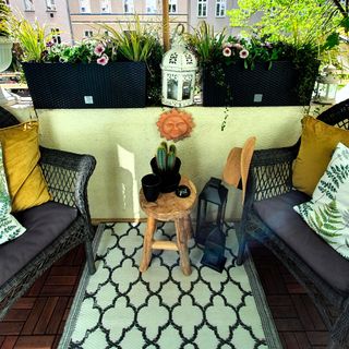 click flooring balcony garden with grey chairs and potted plants